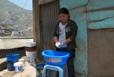 A child domestic worker washes outdoors in Peru