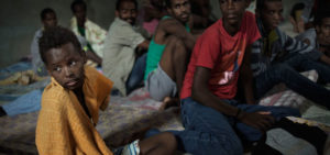 12-year-old Sagga, from Eritrea, sits with other adolescent boys and menin a crowded cell, at the Zawiya detention centre near Tripoli, Libya. Sagga, together with two friends, left Eritrea in the hopes of finding work in Europe to support his family and have a better life. Their journey to Libya took 10 months. He has an uncle in Italy and plans to seek asylum there and attend school.