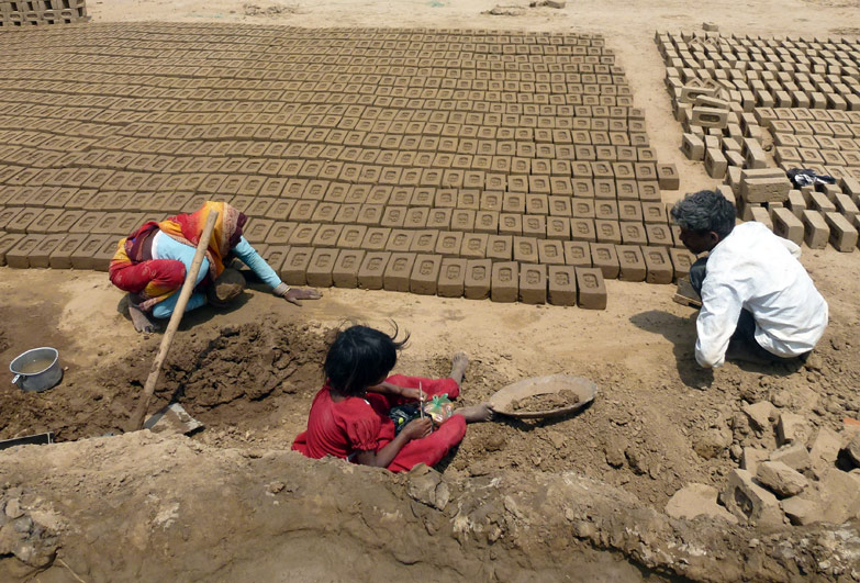 Family working in brick kiln in India