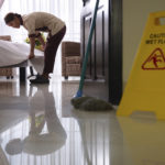 Worker cleaning luxury hotel room