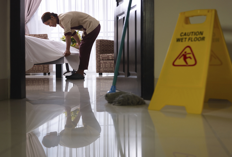 Worker cleaning luxury hotel room