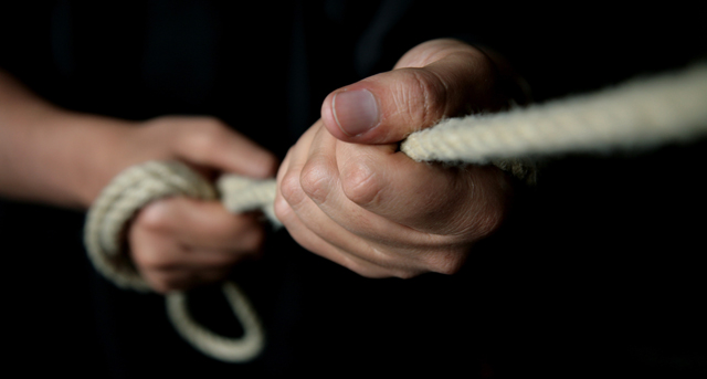 photo of hands pulling ropes