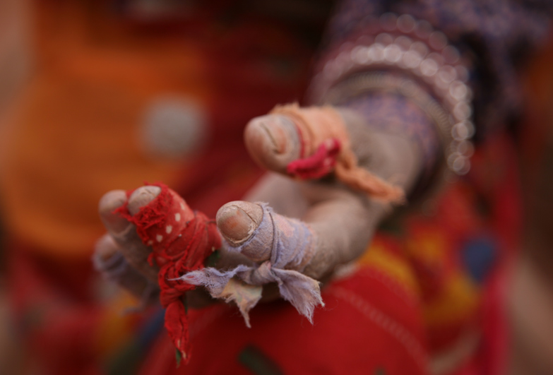 Hand of person in slavery wrapped in cloth for protection