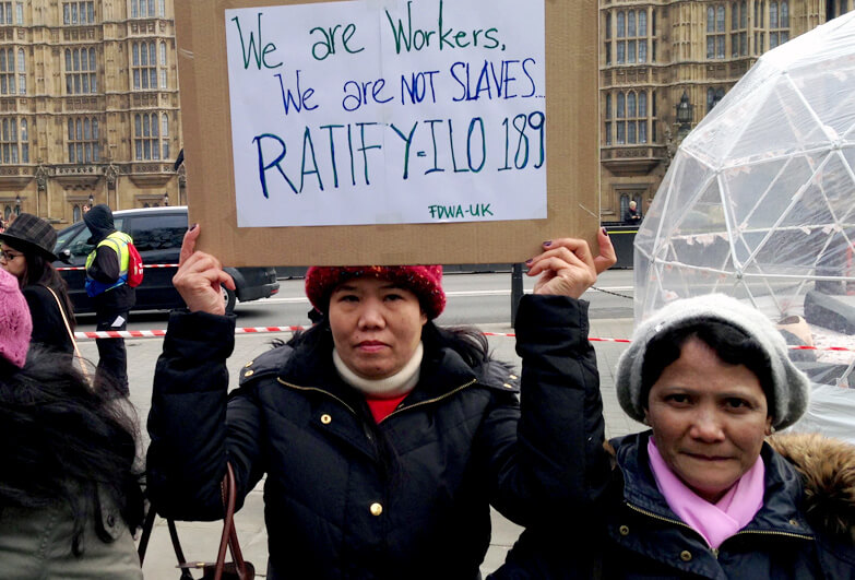 Women outside the UK Parliament demanding protection for migrant domestic workers