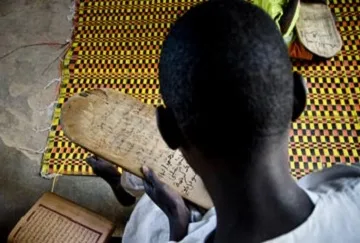A child studies an arabic text
