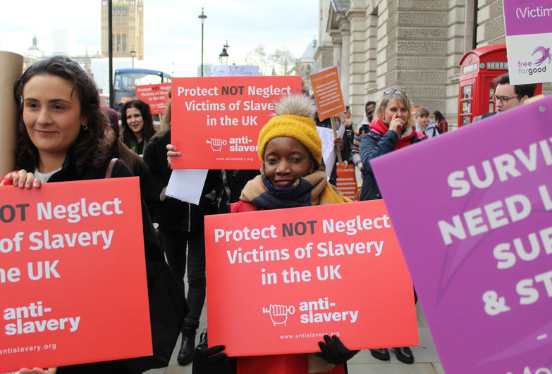 Peition hand in walking down Whitehall London with signs