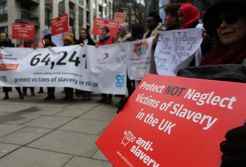 Anti-Slavery supporters holding banners outside the home office