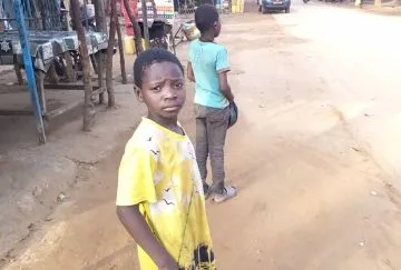 A young boy looks at the camera