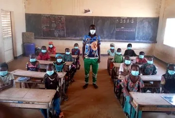 People in a classroom wearing masks