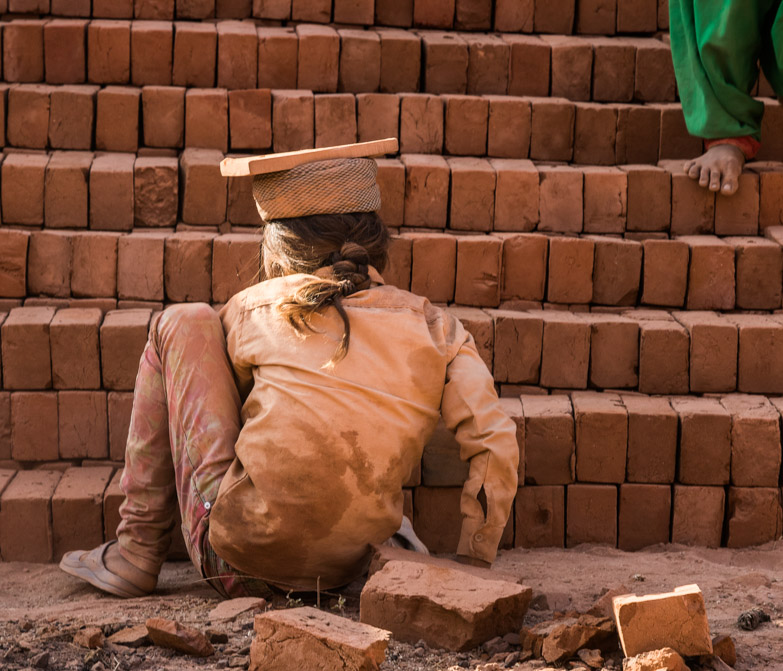 A child works in a brick kiln