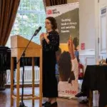 A woman speaks at an Anti-Slavery International event