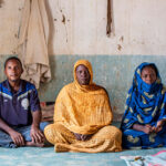 People sitting by Daouda Corera for Anti-Slavery International