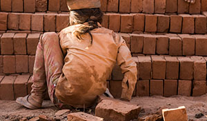 A child working in a brick kiln