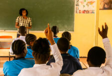 A teacher at the front of a class asks students questions at the vocational school in Tanzania