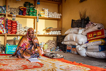 A woman sits in her shop