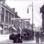 Black and whire photo showing a street scene in Hull, England around 1928. The banner reads Slavery Protest Meeting: Behold, and see if there is any sorrow like unto my sorrow