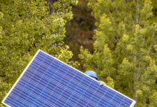A person carries a solar panel
