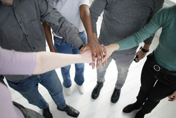 Group hands credit Andrea Piacuadia via Pexels