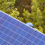 A person carries a solar panel
