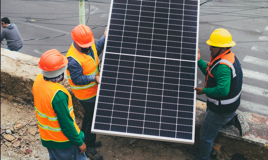 Workers holding solar panels