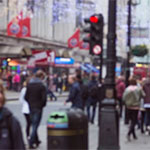 A de-focused image of a UK high street, with a red light