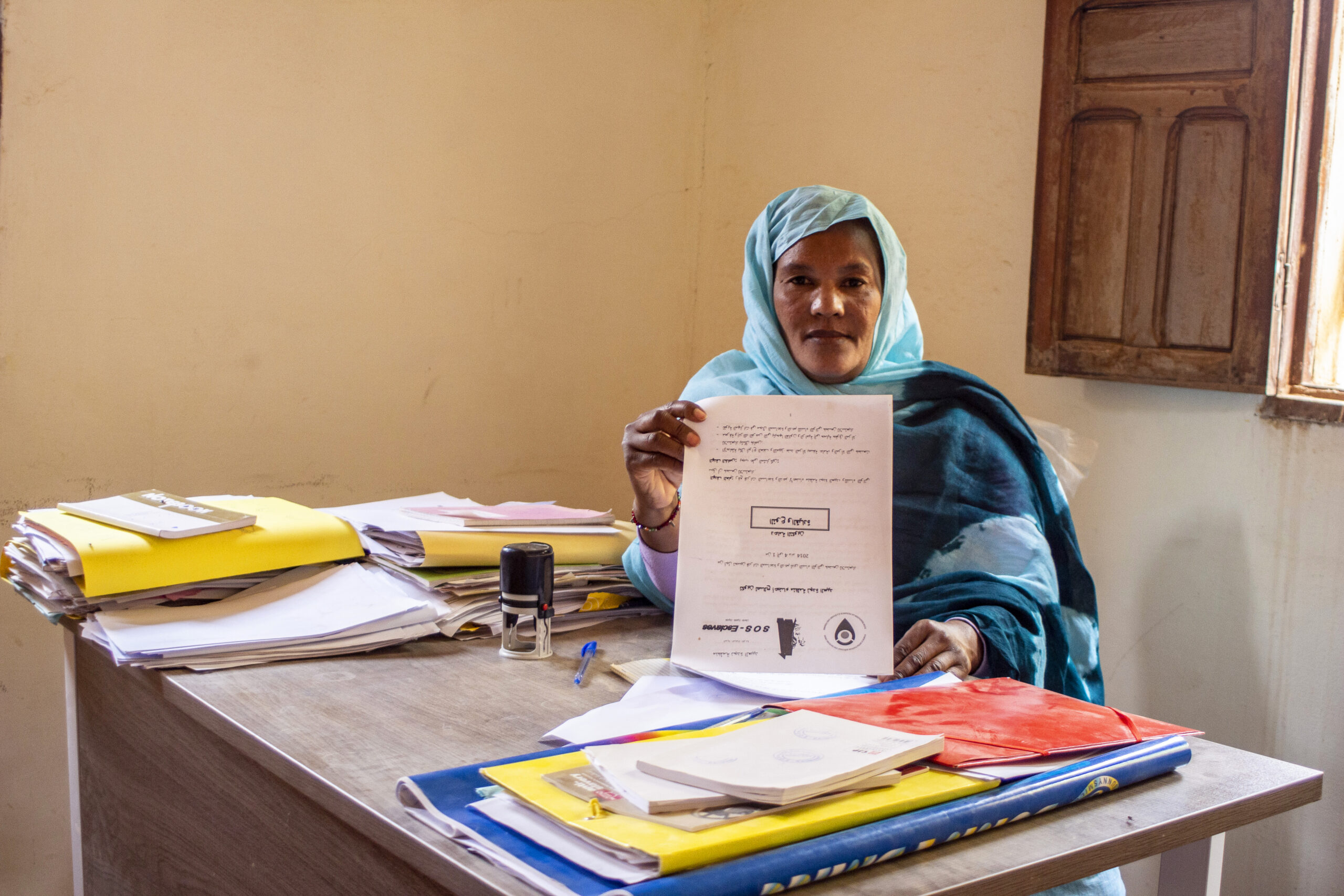 A woman holds up a certificate