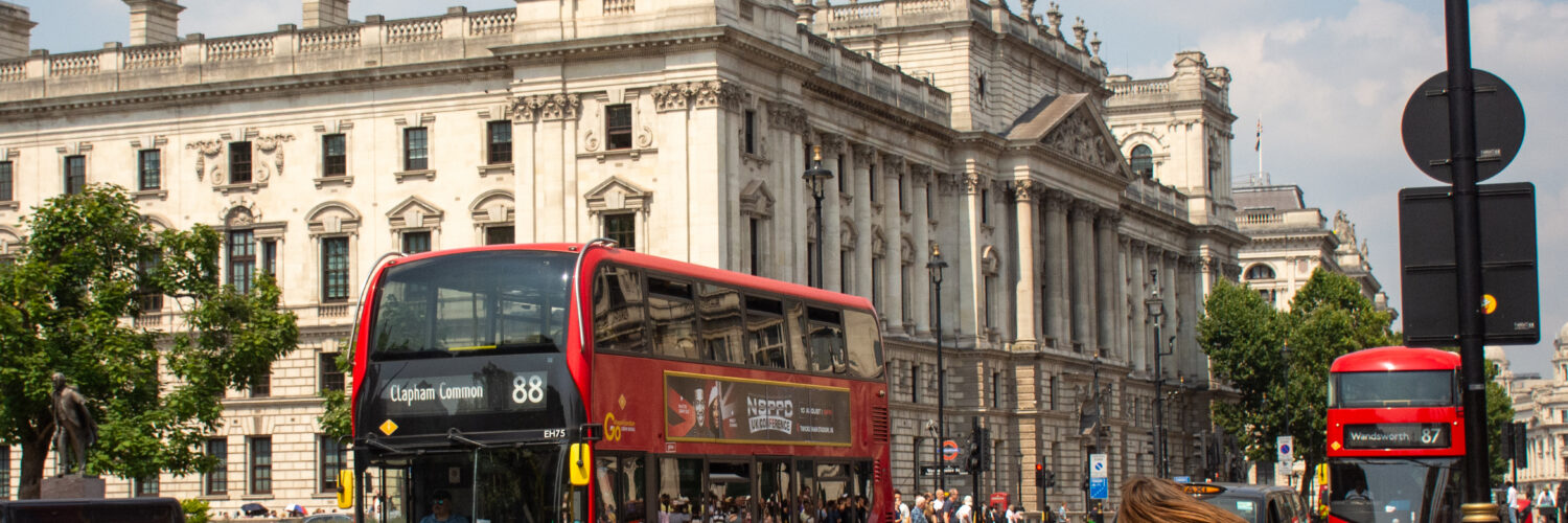 A bus drives past the Houses of Parliament in London